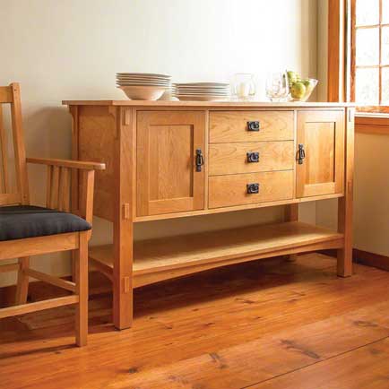 A wooden sideboard in a room with a window.