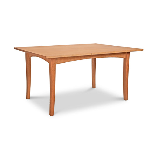 Natural cherry wooden dining table with a rectangle top and four curved legs from the American Shaker Furniture Collection by Maple Corner Woodworks.