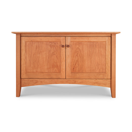 American Shaker 48" TV Stand by Maple Corner Woodworks, showcasing handcrafted elegance with a smooth finish, two doors with round handles, and a curved base in solid hardwoods.