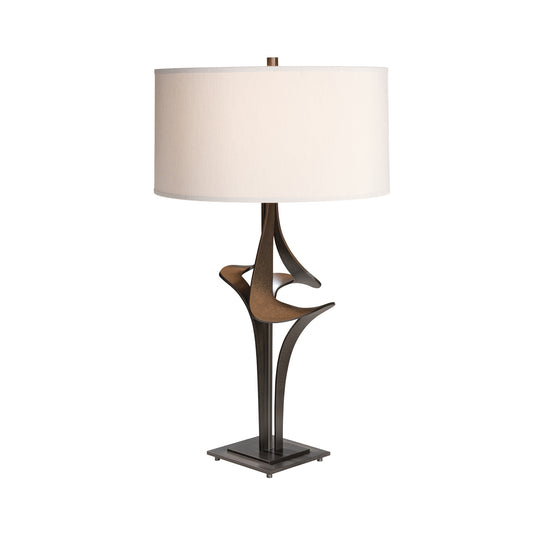 Antasia #2 Table Lamp by Hubbardton Forge with a sculptural dark metal base and large white shade, showcasing elegant American craftsmanship.