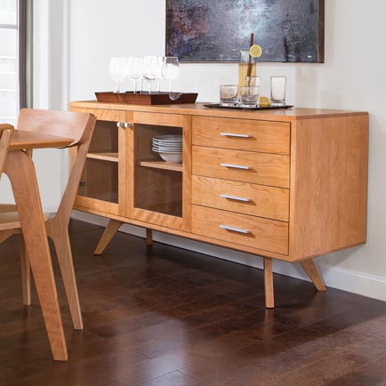 A dining room with a wooden table and chairs.