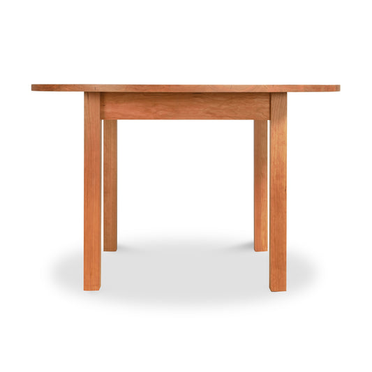 Burlington Shaker Round Solid Top Dining Table by Vermont Furniture Designs featuring four straight legs and a smooth, handcrafted finish.