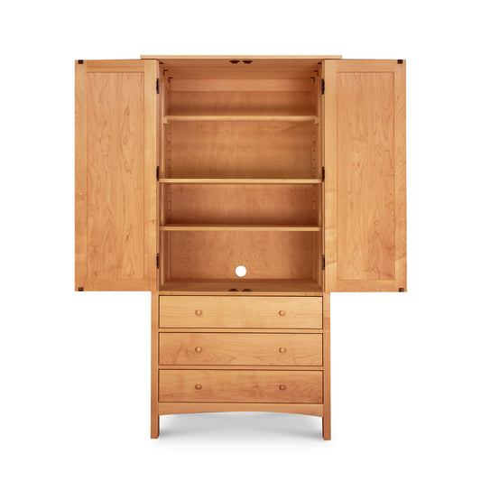 Burlington Shaker Tall Armoire: double doors, three circular shelves, and three drawers by Vermont Furniture Designs.