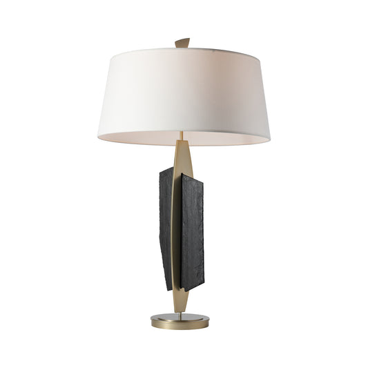 Cambrian Table Lamp by Hubbardton Forge featuring a white shade, metallic base, and handcrafted steel with Vermont black slate accent.
