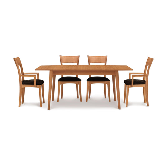 Catalina Extension Table by Copeland Furniture in solid wood with Mid-Century design, shown with four matching chairs featuring black seat cushions.