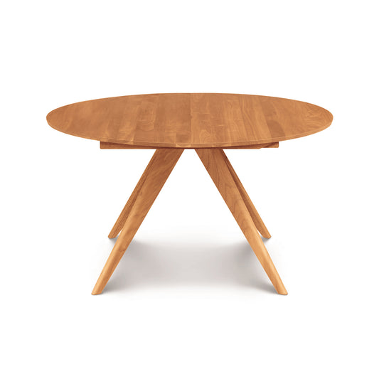 Catalina Round Extension Table by Copeland Furniture, crafted from solid North American wood with four angled legs, showcased for its quality and design.