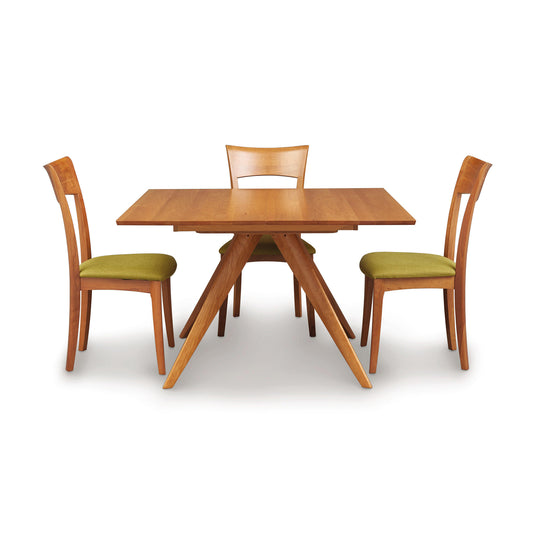 Copeland Catalina Square Extension Dining Table with three matching chairs featuring green cushions, showcasing mid-century design.