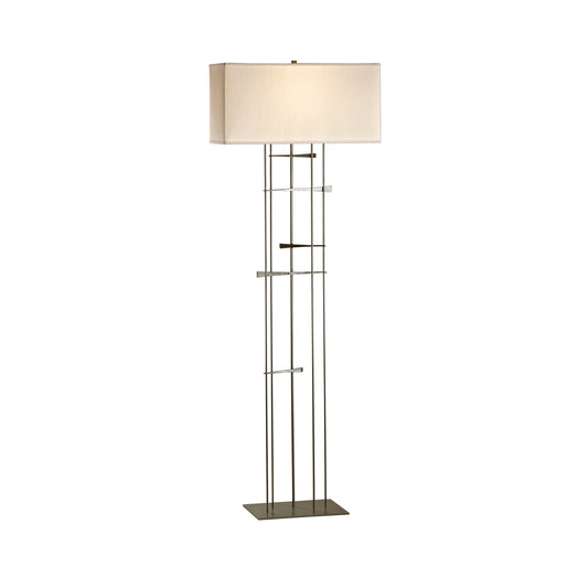 Cavaletti Floor Lamp by Hubbardton Forge, featuring a geometric design with a rectangular shade and sleek metal stand on a flat base.