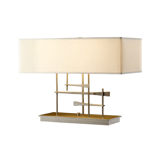 Cavaletti Table Lamp by Hubbardton Forge featuring a modern geometric design with a striking hand-forged wrought iron base and elegant beige fabric shade.
