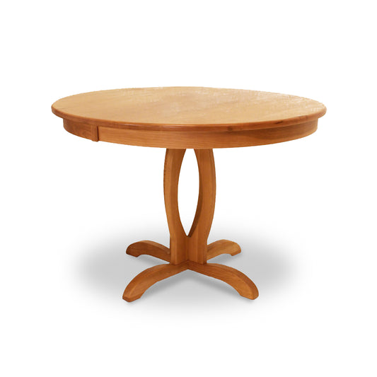 Cherry Blossom Single Pedestal Round Table by Lyndon Furniture, crafted from natural cherry wood with a curved pedestal base, showcasing fine American craftsmanship.