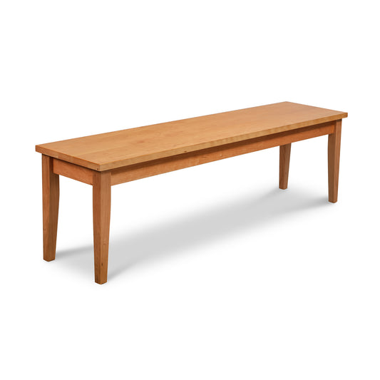 Classic Shaker Bench by Lyndon Furniture with a handcrafted solid wood seat and four sturdy legs, highlighting its traditional design and fine craftsmanship.