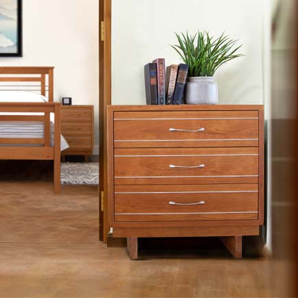 A bedroom with a bed and a dresser.