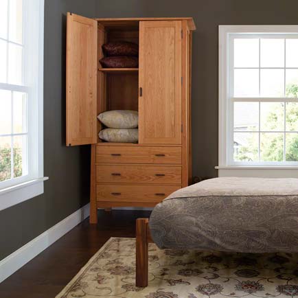 A bedroom with a bed and a dresser.