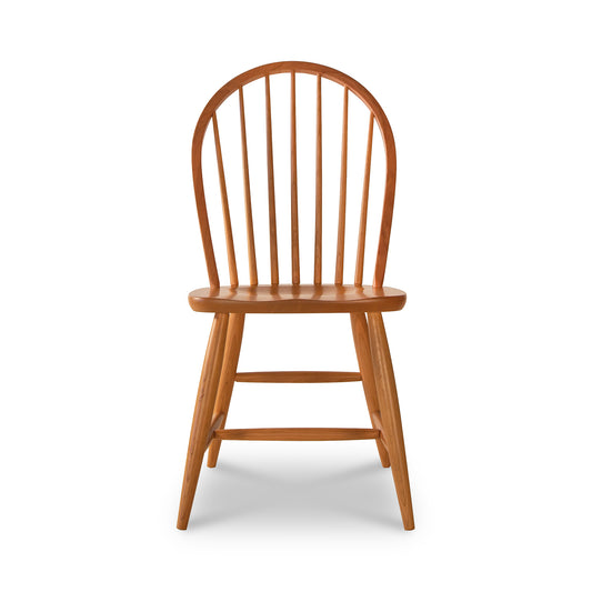 Contemporary Windsor Chair in cherry wood by Lyndon Furniture, featuring a rounded back with vertical slats, smooth seat, and sturdy legs.