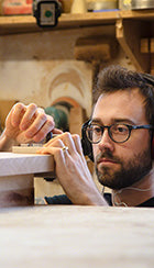 A man is working on a piece of wood.