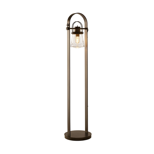 Hubbardton Forge Erlenmeyer Floor Lamp with circular base, lantern-style light, and Edison bulb in tall arched metal frame.