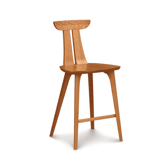 Estelle Counter Stool by Copeland Furniture showcasing a sculpted curved backrest, sturdy four-leg base, and integrated footrest in hardwood.