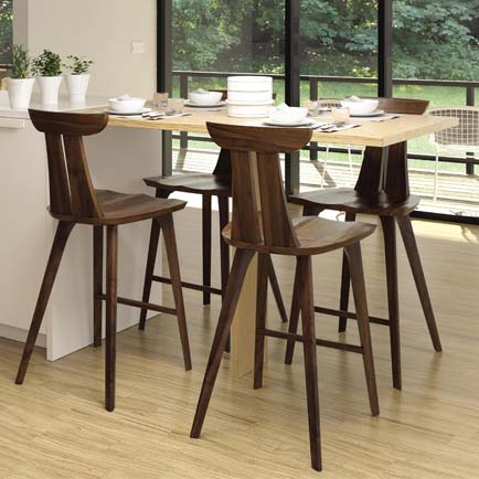 A modern kitchen with a wooden table and chairs.