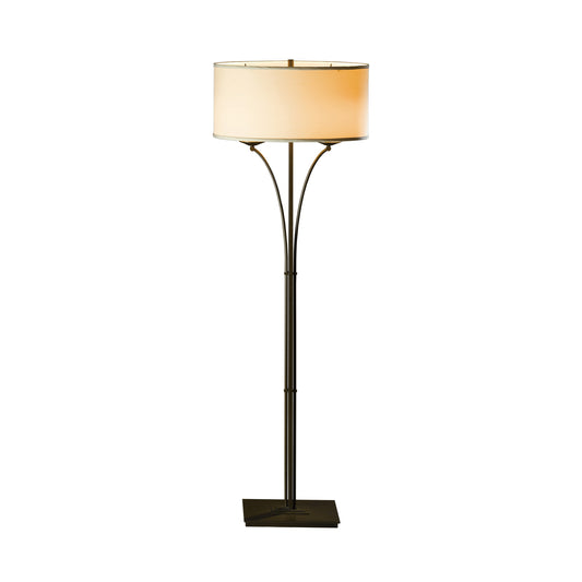 Formae Contemporary Floor Lamp by Hubbardton Forge with circular beige shade, slender metal stand, and square base.
