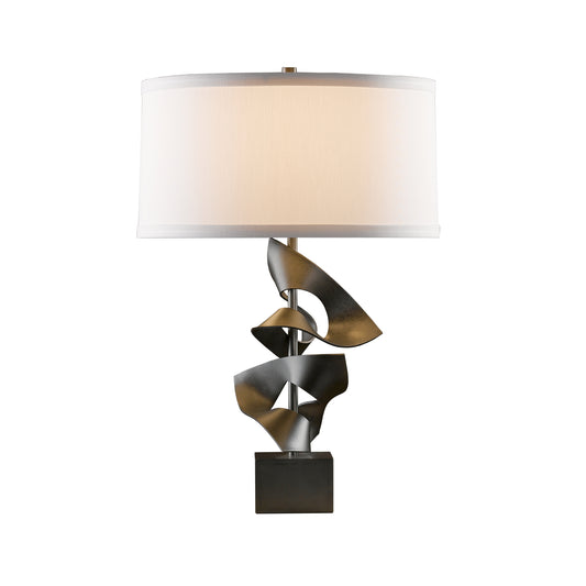 Hubbardton Forge Gallery Two Fold Table Lamp featuring a sculptural metallic base and white rectangular shade, showcasing artisan craftsmanship.