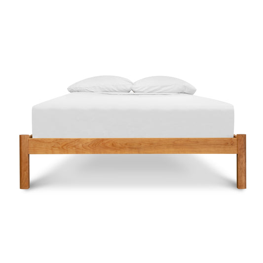 Heartwood Shaker Bed with a handcrafted wooden frame and white mattress.
