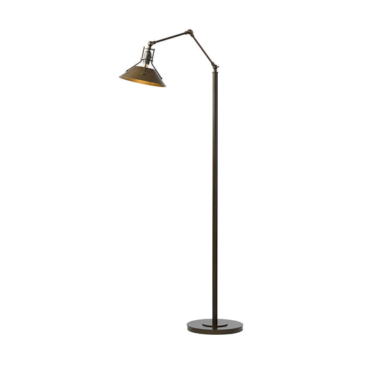 Tall black floor lamp with adjustable arm and metal cone-shaped shade from Hubbardton Forge's Henry collection.