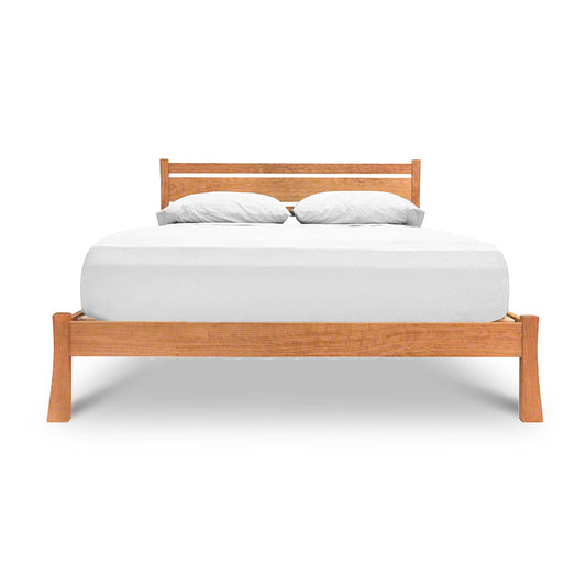 Horizon Platform Bed by Vermont Furniture Designs with wooden frame and headboard, showcasing a white mattress and pillows.