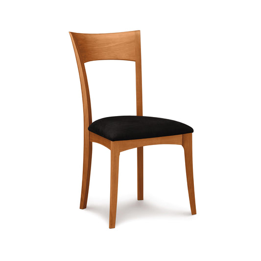 Ingrid Chair by Copeland Furniture, handcrafted in solid American cherry with a curved back and black cushion, made in Vermont.