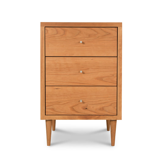 Vermont Furniture Designs Larssen 3-Drawer Nightstand crafted in natural hardwood featuring small knobs and tapered legs.