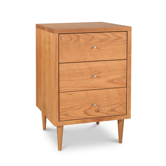 Larssen 3-Drawer Nightstand by Vermont Furniture Designs, crafted from natural hardwood, features a smooth finish, tapered legs, and round metal knobs.