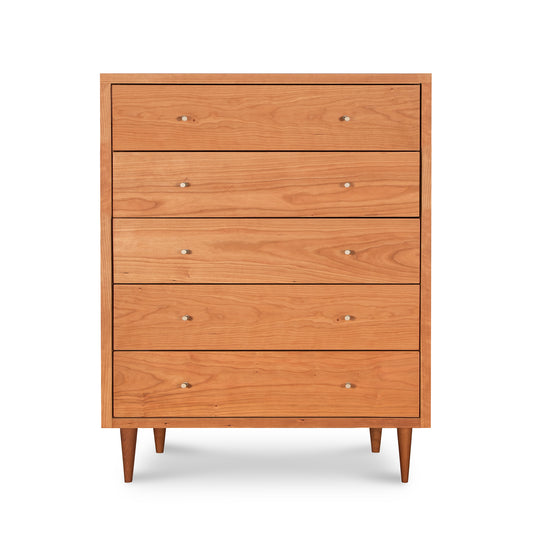 Larssen 5-Drawer Wide Chest by Vermont Furniture Designs, featuring mid-century modern style with round handles and tapered legs, providing ample storage space.