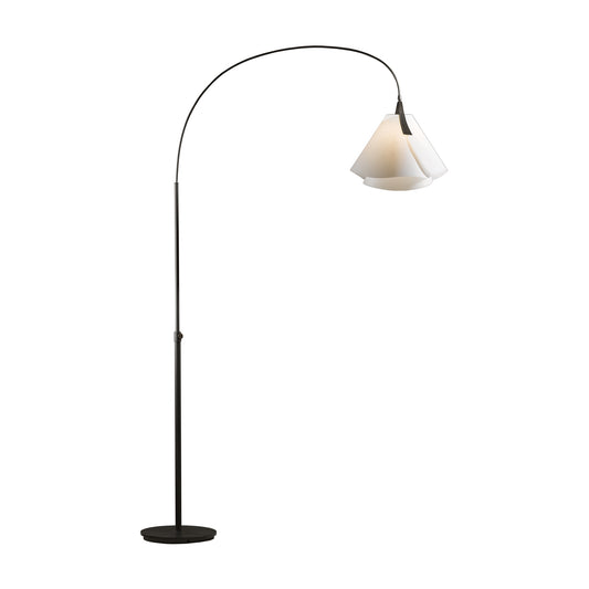 Tall black Mobius Arc Floor Lamp by Hubbardton Forge with a curved arm, white conical shade, and circular base.