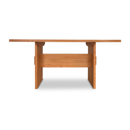 Modern American dining table in solid wood with natural cherry finish and sturdy legs.
