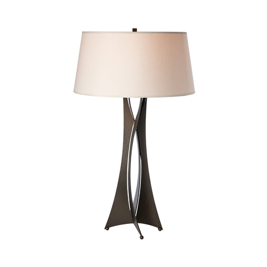 Hand-forged Moreau Table Lamp by Hubbardton Forge with twisted iron base and elegant white drum shade.