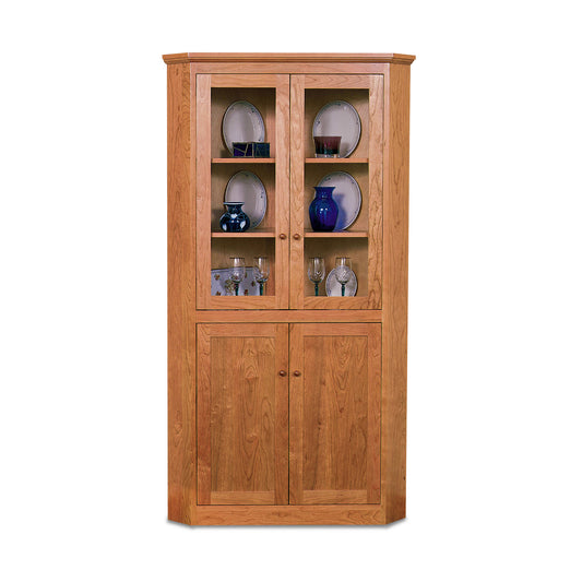 Lyndon Furniture New England Shaker Corner Cabinet with glass doors, expertly crafted from sustainably sourced wood, showcasing classic American craftsmanship.