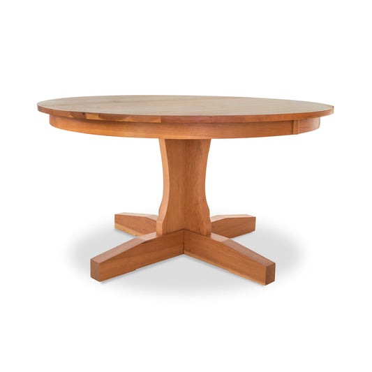 Lyndon Furniture New Traditions Round Pedestal Table with thick solid hardwood top and light wood finish, showcasing elegant craftsmanship.