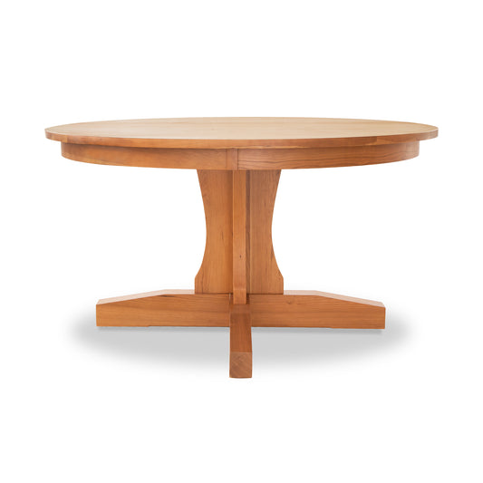 Lyndon Furniture New Traditions Round Pedestal Table made of solid hardwood with a cross-shaped base, showcasing fine craftsmanship and elegant design.