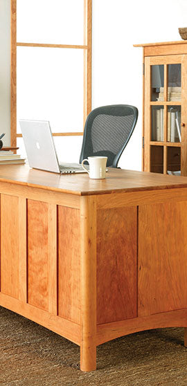 A wooden desk in a room.