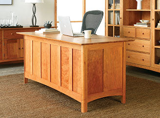 A home office with a desk and bookshelves.