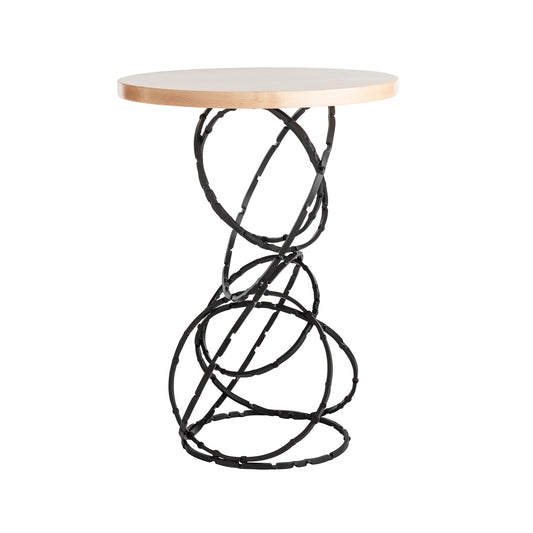 Small round wood top accent table with decorative intertwined circle metal base, from Hubbardton Forge Olympus series. Made in America.