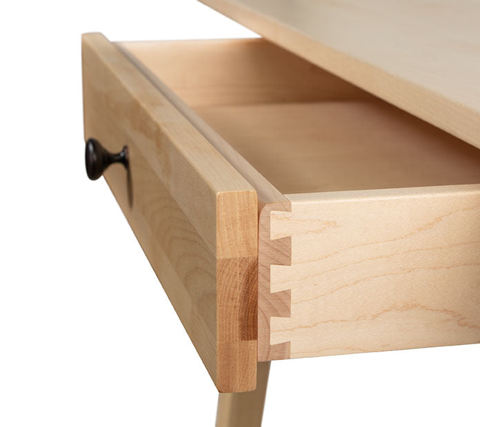 A close up of a wooden desk with a drawer.