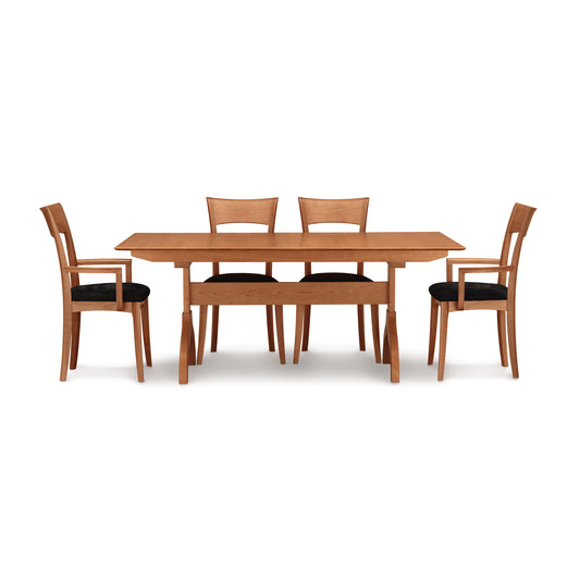 Copeland Sarah Shaker Trestle Extension Table with four Shaker collection chairs featuring black cushions, showcasing finely crafted wood furniture.