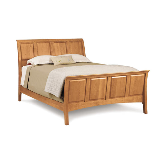 Copeland Furniture Sarah High Footboard Sleigh Bed in solid cherry with paneled design, shown with neatly arranged bedding.