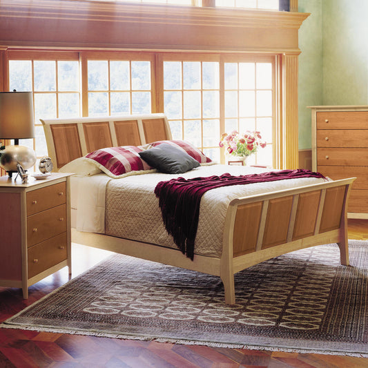 Sarah High Footboard Sleigh Bed by Copeland Furniture showcasing elegant wood craftsmanship and curved headboard, with matching nightstand nearby.
