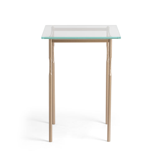 Hubbardton Forge Senza Side Table with clear glass top and artisan steel legs, showcasing sleek modern design.
