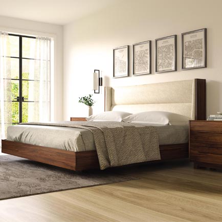 Large wooden-framed bed with a beige headboard in a cozy bedroom setting.