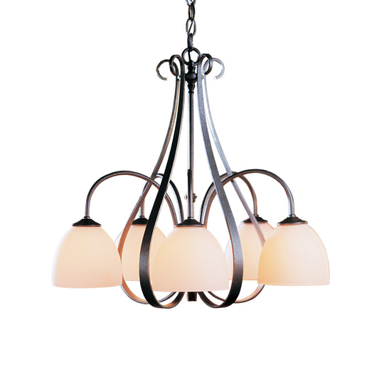 Elegant black hand-forged metal chandelier with five white glass lampshades, resembling the Hubbardton Forge Sweeping Taper design.