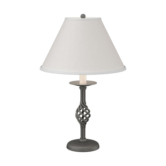 Twist Basket Table Lamp by Hubbardton Forge with a handcrafted dark, twisted metal base and white shade, showcasing elegant Vermont craftsmanship.