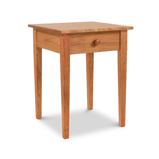 Vermont Shaker Bedside Table with smooth finish, single drawer with round knob, and four sturdy legs, handcrafted from sustainably harvested solid woods.