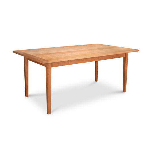 Vermont Shaker Solid Top Harvest Table by Maple Corner Woodworks, classic rectangular dining table with light brown finish and tapered legs.